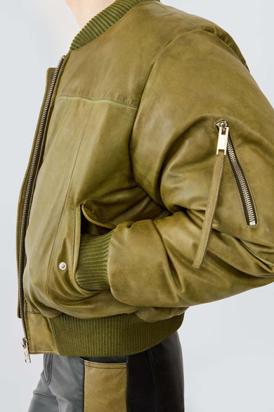Bofinger olive green leather bomber jacket by Deadwood, side view featuring zippered closure and ribbed collar, cuffs, and hem.