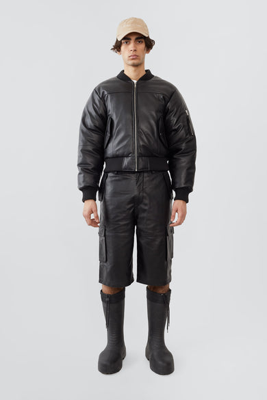 Model wearing Bofinger padded leather bomber jacket by Deadwood, front view with zipper closure and push-button waist pockets, made from upcycled leather.