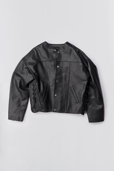 Flat image of The Canoo Leather Jacket, an oversized design made from heavy recycled leather. Features unique leather rope details at the cuffs and sides, duo waist pockets, and a single inside pocket. Lined with recycled PET.