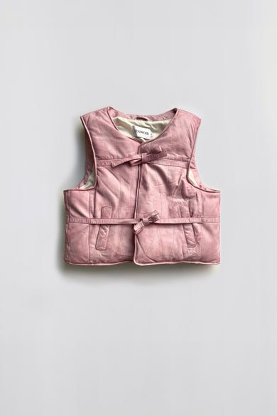 Flat front view of Float leather vest by Deadwood, featuring duo leather straps and waist pockets, crafted from hand-dyed upcycled leather.