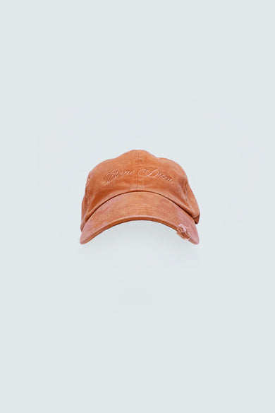 Orange cap with tonal Carpe Diem embrodery on a light gray background