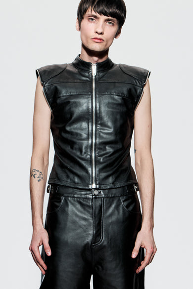 Front view of Dita Jacket worn as vest on male model, showing sleek sleeveless silhouette and polished leather finish.
