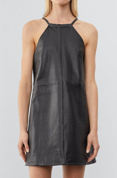 Front view of a model wearing The Kimi Dress, a short, chic cocktail dress made from black upcycled leather. The dress features a slightly A-line shape for a flattering silhouette, with a back slit for added movement and style.