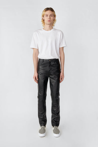 Man wearing black Phoenix slim-fit leather pants by Deadwood, made from recycled leather and PET bottles.