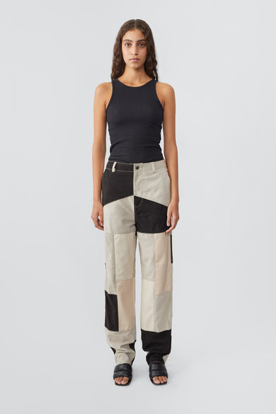 Model in women’s Phil Patchwork Leather Pants with vibrant design, crafted from upcycled lamb nappa and goat suede, lined with recycled PET fabric.