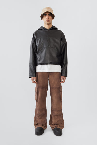 
A male model wearing the Deadwood Cargo Leather Pants. These workwear-inspired leather pants feature a wide, relaxed fit with a flowing silhouette. Designed with double waist pockets, multiple cargo pockets with hidden push-button closures, and a mid-waist zip fly. Crafted from upcycled leather and lined with fabric made from 100% recycled plastic bottles.