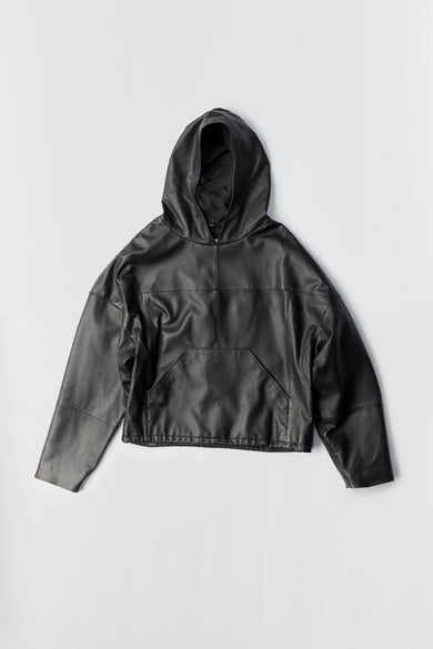Picture of he Homer Hoodie in black, made from recycled lambskin leather. The hoodie features a front kangaroo pocket, cozy hood, and a drawstring at the bottom hem. The outer shell is crafted from upcycled leather, and the lining is made from recycled PET bottles for a sustainable design.