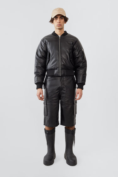 Model wearing Bofinger padded leather bomber jacket by Deadwood, front view with zipper closure and push-button waist pockets, made from upcycled leather.
