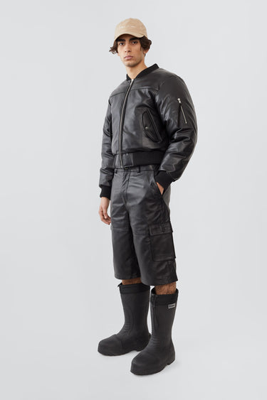 Side view of model wearing Bofinger padded leather bomber jacket by Deadwood, ribbed hem and cuffs, crafted from upcycled leather.