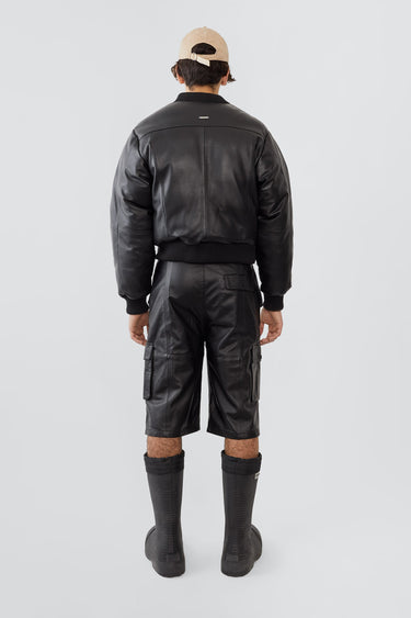 Back view of model wearing Bofinger padded leather bomber jacket by Deadwood, ribbed hem and cuffs, crafted from upcycled leather.
