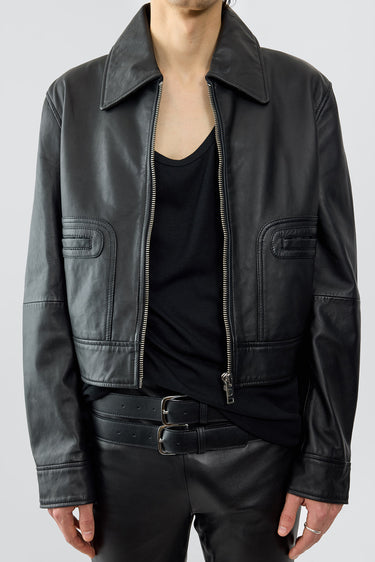Model wearing Gable jacket in black, with a cropped cut and features front pockets. Made from recycled leather.