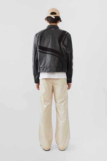 Model from the back in Hiro black leather jacket by Deadwood, inspired by Japanese motorcycle culture.