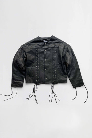 Black leather jacket with strap details on a white background