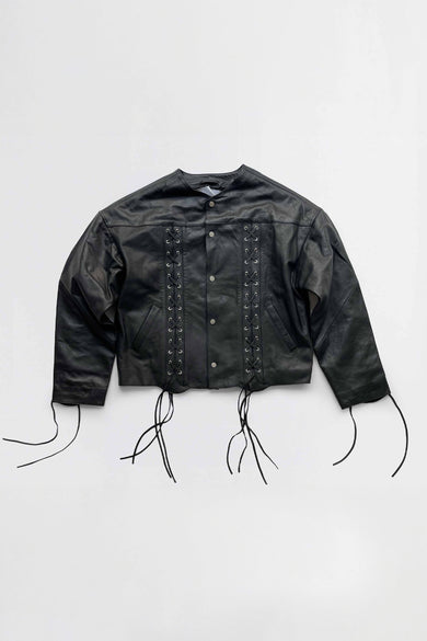 Black leather jacket with strap details on a white background