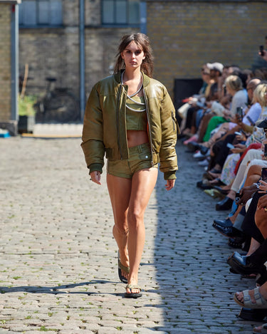Female model on runway wearing olive Bofinger jacket and olive Hotz Shorts from Deadwood Spring/Summer 2025 Collection during Copenhagen Fashion Week