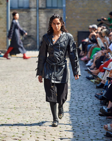 Female model on runway wearing black leather jacket from Deadwood Spring/Summer 2025 Collection during Copenhagen Fashion Week