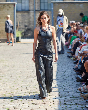 Female model on runway wearing black leather dress from Deadwood Spring/Summer 2025 Collection during Copenhagen Fashion Week. The look features upcycled leather and recycled cotton, reflecting the brand’s commitment to sustainable fashion
