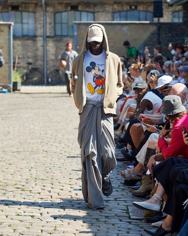 Male model on runway wearing beige suede jacket from Deadwood Spring/Summer 2025 Collection during Copenhagen Fashion Week. The look features upcycled leather and recycled cotton, reflecting the brand’s commitment to sustainable fashion