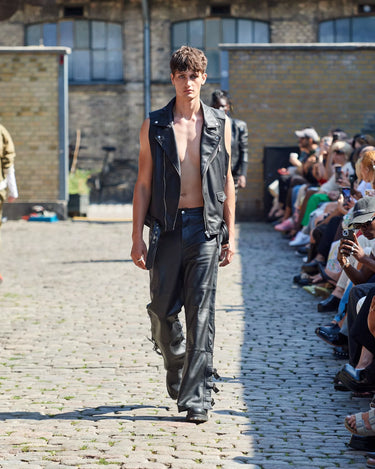 Male model on runway wearing black leather outfit from Deadwood Spring/Summer 2025 Collection during Copenhagen Fashion Week. The look features upcycled leather reflecting the brand’s commitment to sustainable fashion