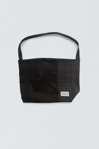 Picture of sling bag in blue and checked blue, made out of cotton and wool off-cuts from deadwoods main production. 