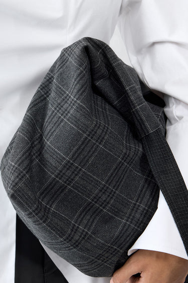 Detailed picture of sling bag in blue and checked blue, made out of cotton and wool off-cuts from deadwoods main production. 