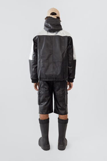Picture of a model wearing Tycho jacket.
The Tycho Jacket is a leather and aluminum parka featuring a cozy hood, orange lining, and drawstring hem for an adjustable fit. It includes side pockets, an inside pocket, and is crafted from upcycled leather, recycled polyester with an aluminum coating, and lined with recycled PET bottles for a sustainable design.