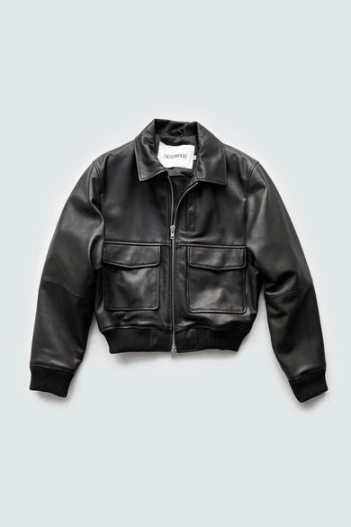 The Wingman by Deadwood is a sleek, cropped black leather jacket with a straight-cut and boxy fit. Made from upcycled lamb nappa and lined with 100% recycled plastic bottles for a sustainable, stylish look.