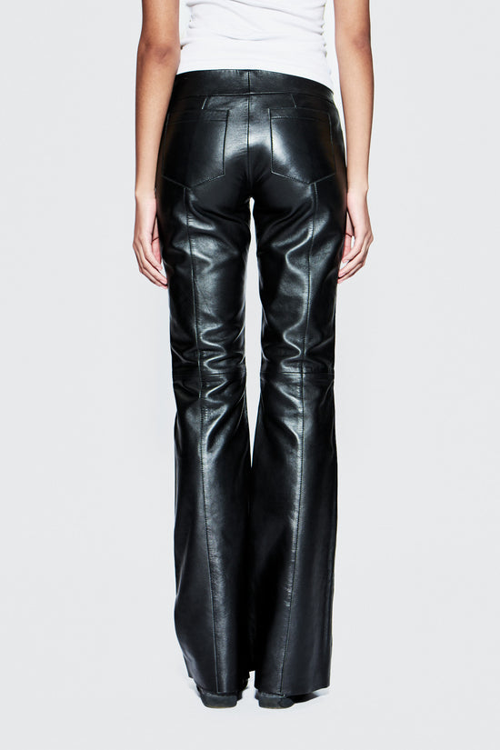 Black leather pants worn by a person on a white background