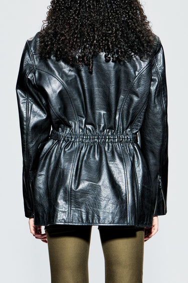 Back view of Ann Jacket by Deadwood on model, showing fixed gathered waist detail and sculpted back paneling in upcycled leather.