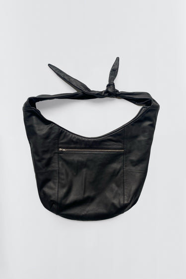 Boel Bag by Deadwood, flat lay showing crossbody sling design with adjustable knotted strap and zippered compartments in black upcycled leather.