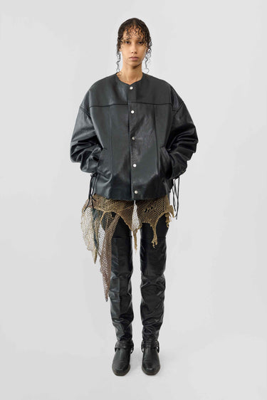 Front view of female model wearing Canoo Jacket in black upcycled leather, featuring drawstrings in cufs and duo waist pockets.