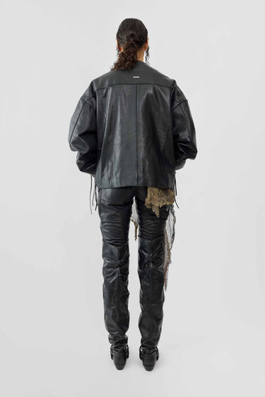 Back image of female model wearing Canoo Jacket in black upcycled leather, featuring drawstrings in cufs and duo waist pockets.
