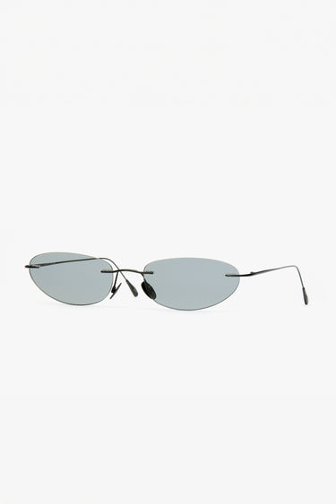 Side profile of Colletti sunglasses showing ultra-light matte black recycled steel arms and smoked gunmetal lenses.