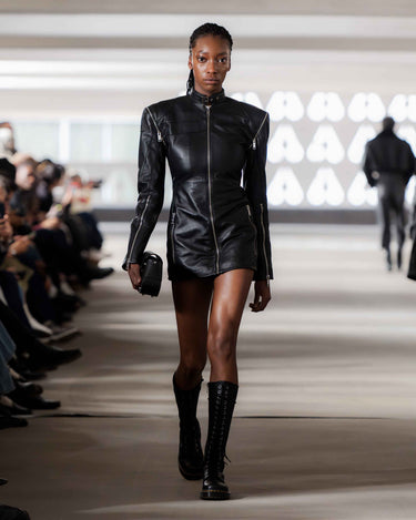 Model wearing a black leather outfit styled with Dr Martens on Deadwood pre-spring 2026 runway show. 