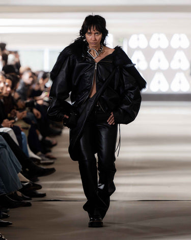 Model walking on Deadwood pre-spring 2026 runway show wearing a black leather outfit.