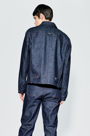 Close up of raw denim jacket back view, showing adjustable straps and stitching