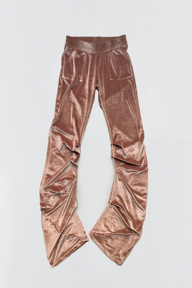 Flat view of the Drape pants in Copper Coin. Draped velvet pants in a copper shade with a high waist, wide waistband, and large front pockets. Wide legs with a ruched effect along the sides.