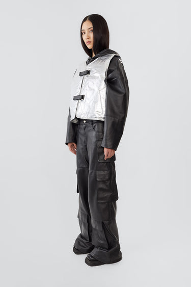 Side view of a female model wearing the Kapok Vest by Deadwood in Aluminium. Crafted from upcycled deadstock goat suede with a subtle brushed effect, this one-off sample style offers a relaxed, textured look.