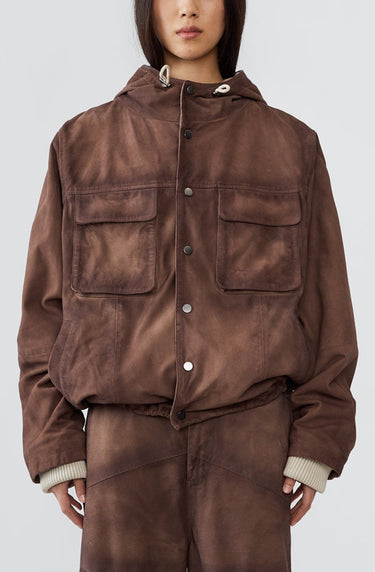 Person wearing a brown jacket and pants set on a white background