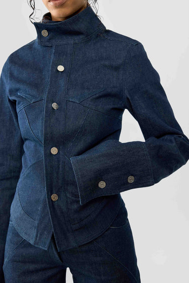 Blue raw denim jacket with button details on a white background