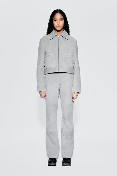 Front view of a model wearing a gray suede outfit on a white background