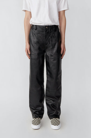 Person wearing black cargo pants and a white shirt on a plain background