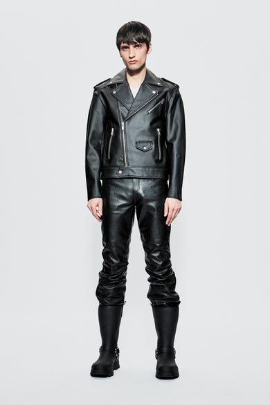 Model wearing a black cactus leather outfit on a light gray background