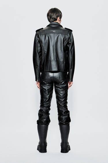Model wearing a black cactus leather outfit on a light gray background