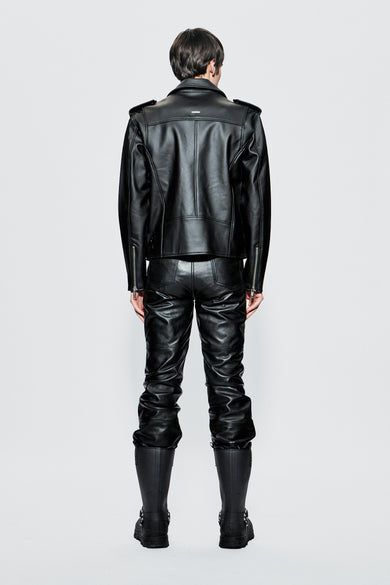 Model wearing a black cactus leather outfit on a light gray background
