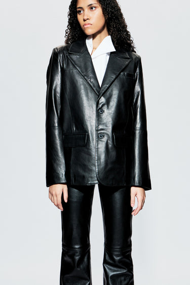 Model wearing a black leather blazer and black leather pants