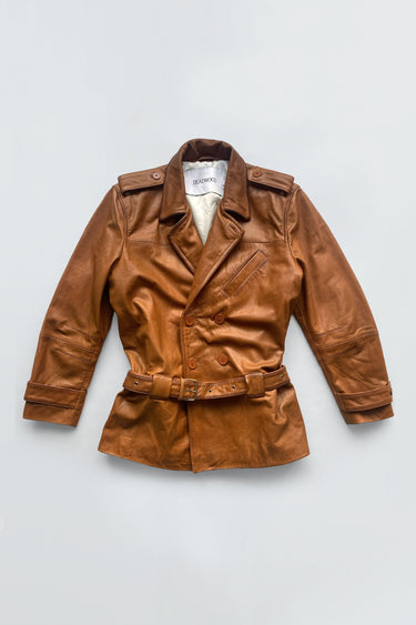 Cognac colored leather jacket on a light gray background
