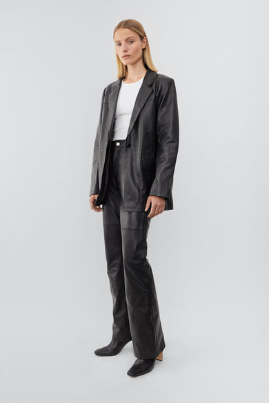 Model wearing Black Deadwood leather blazer with a beautiful oversized fit, single-button closure. Made from recycled lambskin leather.