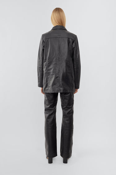 Model wearing Black Deadwood leather blazer with a beautiful oversized fit, single-button closure. Made from recycled lambskin leather.