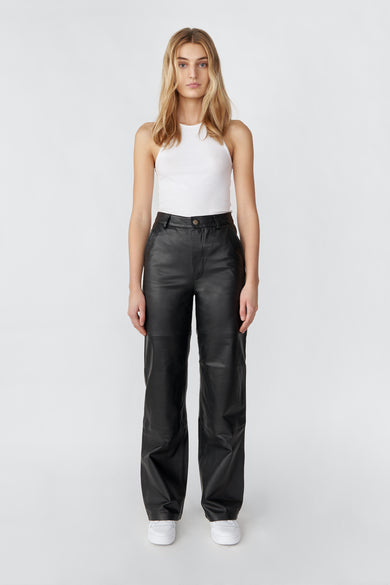 Model wearing black Deadwood leather pants with a casual straight to semi wide fit. Made from recycled leather.